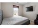 Bedroom with a window and mounted television at 4007 Newell Ln, Raleigh, NC 27616