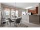 Dining area with a round table, chairs, modern light fixture, and an adjacent kitchen area at 4007 Newell Ln, Raleigh, NC 27616