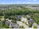Expansive aerial view of a neighborhood featuring well-maintained homes surrounded by lush trees at 401 Clingstone Ct, Cary, NC 27519