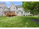 Spacious backyard showcasing well-maintained lawn, a deck, and the home's rear elevation at 401 Clingstone Ct, Cary, NC 27519