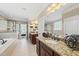 Open bathroom with granite countertops, shower, and bathtub at 401 Clingstone Ct, Cary, NC 27519