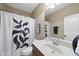 Modern bathroom featuring neutral paint, a mirror, and large shower curtain at 401 Clingstone Ct, Cary, NC 27519