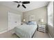 Comfortable bedroom featuring closet, side tables, lamps and large window for natural light at 401 Clingstone Ct, Cary, NC 27519
