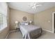 Comfortable bedroom with a ceiling fan, window, and a comfortable bed at 401 Clingstone Ct, Cary, NC 27519