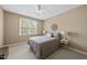 Cozy bedroom with a ceiling fan, window, and a comfortable bed at 401 Clingstone Ct, Cary, NC 27519