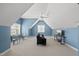 Spacious bonus room with ample light, and seating area with couch, table, and tv at 401 Clingstone Ct, Cary, NC 27519