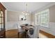 Elegant dining room with hardwood floors, wainscoting, and natural light at 401 Clingstone Ct, Cary, NC 27519