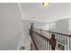 Bright hallway with an overlook of the living room that has a fireplace, and staircase with wooden banister at 401 Clingstone Ct, Cary, NC 27519