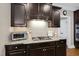 Modern kitchen features dark wood cabinets, granite countertops, and stainless steel appliances at 401 Clingstone Ct, Cary, NC 27519