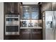 Close up on stainless steel oven and refrigerator in custom kitchen at 401 Clingstone Ct, Cary, NC 27519