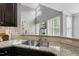 Close up on granite countertops and stainless steel kitchen sink at 401 Clingstone Ct, Cary, NC 27519