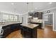 Open concept kitchen with stainless steel appliances and granite countertops at 401 Clingstone Ct, Cary, NC 27519