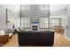 Bright, open living room with fireplace, hardwood floors, and large windows at 401 Clingstone Ct, Cary, NC 27519