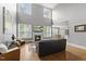 Bright living room featuring hardwood floors, fireplace, and high ceilings at 401 Clingstone Ct, Cary, NC 27519
