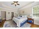 Large main bedroom with tray ceiling, hardwood floors, and access to main bathroom at 401 Clingstone Ct, Cary, NC 27519