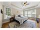 Spacious main bedroom with tray ceiling, hardwood floors, and lots of natural light at 401 Clingstone Ct, Cary, NC 27519