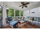 Inviting screened porch with comfortable seating and a ceiling fan overlooking the beautiful greenery at 401 Clingstone Ct, Cary, NC 27519