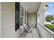 Cozy porch with seating, decorative pillows, and a view of the manicured lawn at 401 Clingstone Ct, Cary, NC 27519
