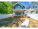 Beautiful backyard featuring lush greenery, a wooden porch, and a white picket fence at 407 1/2 Carolina Ave, Raleigh, NC 27606