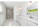 Modern bathroom featuring a double vanity, glass shower, and marble tile flooring at 407 1/2 Carolina Ave, Raleigh, NC 27606