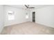 Bright bedroom features a neutral carpet, two windows, and a modern ceiling fan at 407 1/2 Carolina Ave, Raleigh, NC 27606
