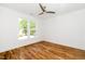 Bright bedroom with gleaming hardwood floors, ceiling fan, and abundant natural light at 407 1/2 Carolina Ave, Raleigh, NC 27606