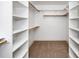 Spacious walk-in closet featuring custom shelving and carpet flooring at 407 1/2 Carolina Ave, Raleigh, NC 27606