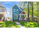 Charming two-story blue home features a welcoming front porch and well-maintained lawn at 407 1/2 Carolina Ave, Raleigh, NC 27606