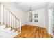 Inviting foyer with hardwood floors, staircase, and double doors leading to another room at 407 1/2 Carolina Ave, Raleigh, NC 27606