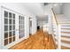 Entryway boasting hardwood floors, staircase, and views of the kitchen and adjacent living space at 407 1/2 Carolina Ave, Raleigh, NC 27606