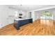 Modern kitchen with island, white cabinets, stainless steel appliances, and hardwood flooring at 407 1/2 Carolina Ave, Raleigh, NC 27606
