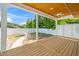 Spacious covered porch with a wood ceiling, fan, and a view of the fenced backyard at 407 1/2 Carolina Ave, Raleigh, NC 27606