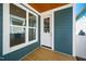 Covered porch with wood flooring, white trim, and exterior door with glass at 407 1/2 Carolina Ave, Raleigh, NC 27606