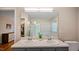 Well-lit bathroom featuring a double vanity, large mirror, and a separate shower and bathtub at 4713 Little Falls Dr, Raleigh, NC 27609
