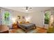 Cozy bedroom with a queen-size bed, natural light, wood floors, and tasteful decor at 4713 Little Falls Dr, Raleigh, NC 27609