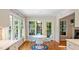 Sunny breakfast nook with hardwood floors, a round table, and large windows with backyard views at 4713 Little Falls Dr, Raleigh, NC 27609