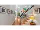 Bright foyer featuring a staircase, hardwood floors, and natural light filtering through the windows at 4713 Little Falls Dr, Raleigh, NC 27609