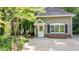 Charming home featuring a welcoming entrance with a white front door and manicured landscaping at 4713 Little Falls Dr, Raleigh, NC 27609