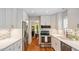 Modern kitchen with stainless steel appliances, white cabinets, and stylish backsplash at 4713 Little Falls Dr, Raleigh, NC 27609