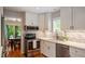 Bright kitchen featuring stainless steel appliances, white cabinets, and stylish backsplash at 4713 Little Falls Dr, Raleigh, NC 27609
