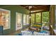 Comfortable screened-in porch with wood ceiling and cushioned seating offers serene outdoor relaxation at 4713 Little Falls Dr, Raleigh, NC 27609