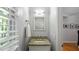 Charming powder room with granite countertop, decorative mirror, and neutral tones at 4713 Little Falls Dr, Raleigh, NC 27609