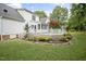 Expansive backyard featuring a spacious deck, manicured lawn, and elegant landscaping at 4812 Cornoustie Ct, Holly Springs, NC 27540