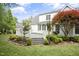 Well-maintained backyard with a spacious deck, lush lawn, and beautifully landscaped garden beds at 4812 Cornoustie Ct, Holly Springs, NC 27540