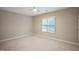 Bedroom showcasing neutral walls, plush carpet, and a window with blinds at 4812 Cornoustie Ct, Holly Springs, NC 27540