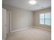 Simple bedroom features neutral carpeting, a window for natural light, and a closet at 4812 Cornoustie Ct, Holly Springs, NC 27540