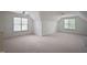 Spacious bonus room features plush carpet, two windows, and ceiling fans at 4812 Cornoustie Ct, Holly Springs, NC 27540