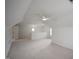 Expansive bonus room with plush carpeting, neutral walls, and a ceiling fan at 4812 Cornoustie Ct, Holly Springs, NC 27540