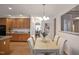 Bright dining area featuring a wooden table, upholstered chairs, and views to the kitchen at 4812 Cornoustie Ct, Holly Springs, NC 27540