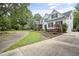 Spacious home with white siding and black shutters, featuring a long driveway leading to the garage and a well-kept lawn at 4812 Cornoustie Ct, Holly Springs, NC 27540